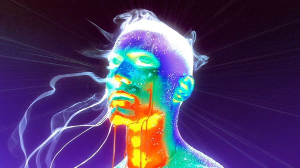 An ethereal silhouette stands fixed, his visage melting into iridescent cascades of dripping latex that bleed electric teal and radiant orange against a deep violet void, the RGB inversion rendering skin tones into spectral pastel streams. Plasma-white accents rim his slightly turned head, flickering as if caught between worlds, while ghostly silk tendrils vaporize upwards, caught mid-motion in swirling trails. Coarse grain clusters cluster densely around the face, dust specks drifting like forgotten memories, and a faint gate-weave jitter distorts the edges with subtle tremors. Radial blur streaks pulse outward, as if the very moment unspools before the eye, suffused with spectral after-image halos. The photo quality suggests a slightly grainy or low-resolution digital look, capturing a candid moment. Shot using a Canon EOS R5 paired with an RF 85 mm ƒ/1.2 lens, layered with scanned 800 ISO tungsten film overlay to fuse the analogue grit with digital surrealism—surreal inverted-color fashion editorial, heavy film grain texture